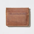 Brown leather wallet on a light beige background