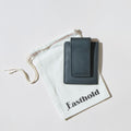 Black leather card clip wallet on a branded white pouch with 'Easthold' branding.